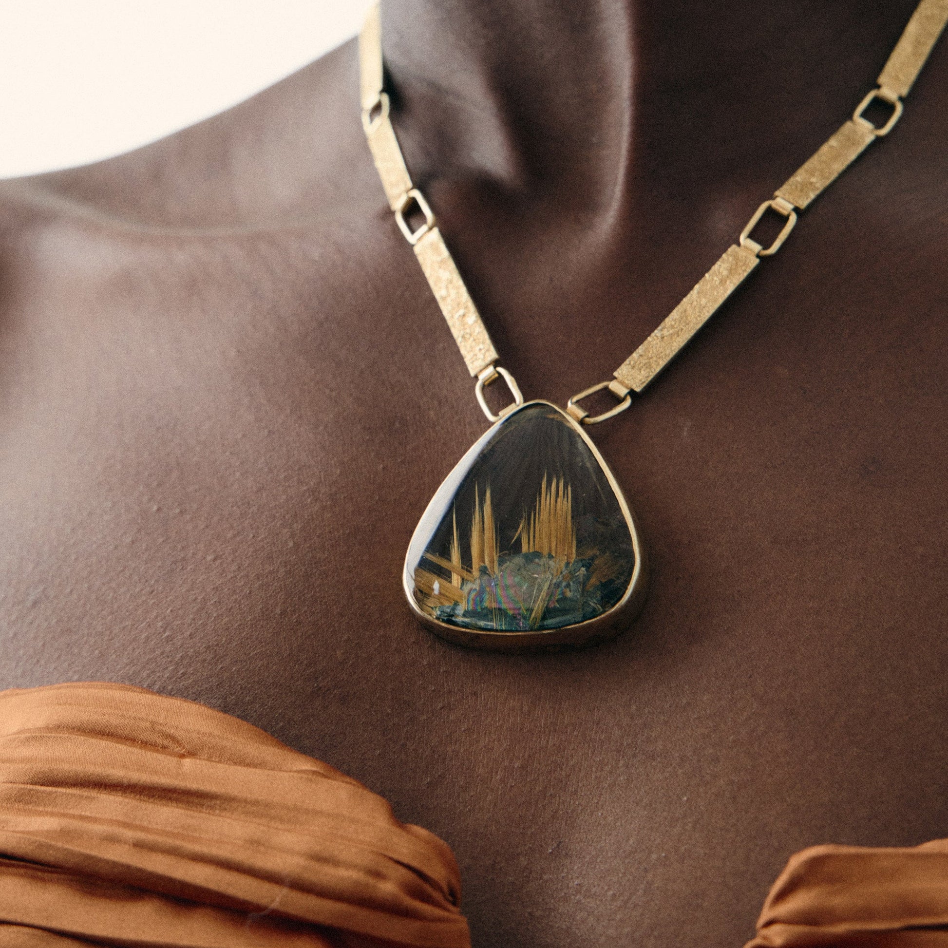 Necklace with a pendant on a model against a neutral background
