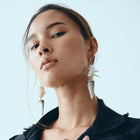 Woman wearing a black jacket with a light blue background